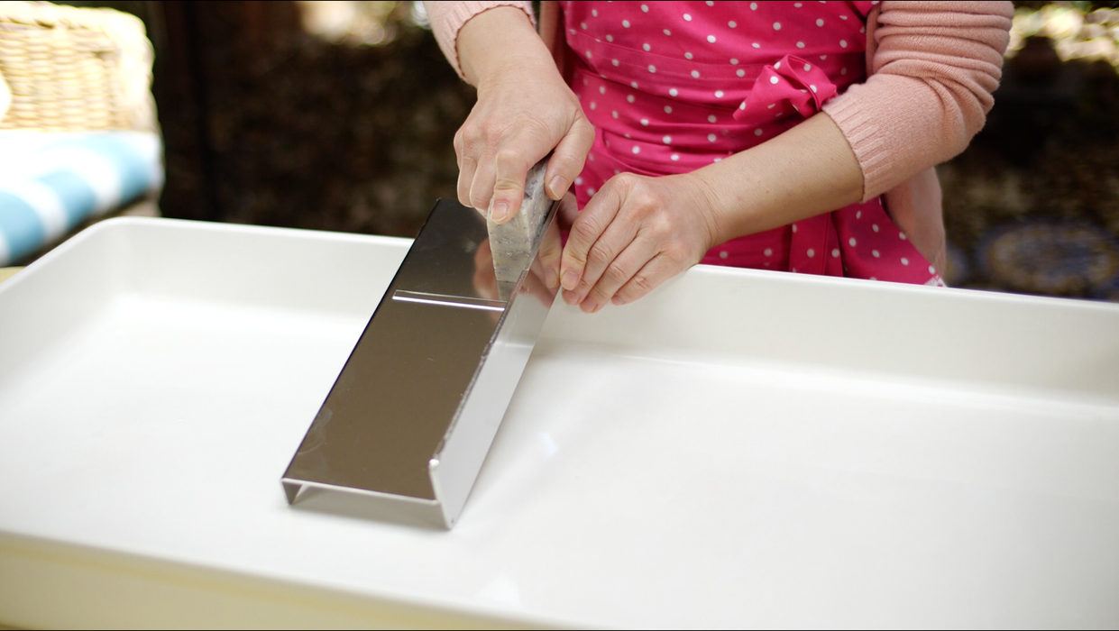 Heavy-duty bladeless stainless steel soap trimmer in action.