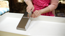 Heavy-duty bladeless stainless steel soap trimmer in action.
